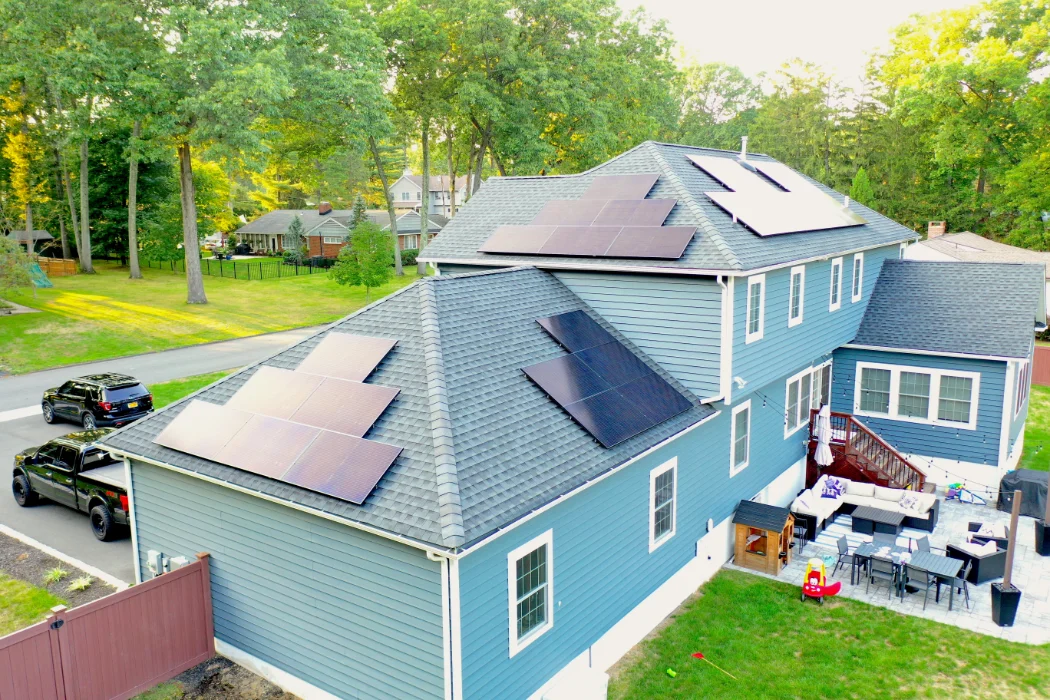 a blue house with solar panels on the roof