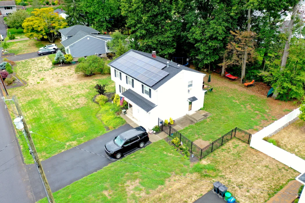 an aerial view of a house with a car parked in front